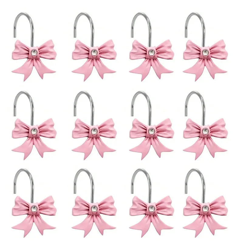 A set of twelve pink decorative bow tie shower curtain hooks with silver metal rings.