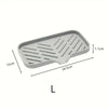 A rectangular silicone sink mat with ridges used as a kitchen organizer and drying rack.