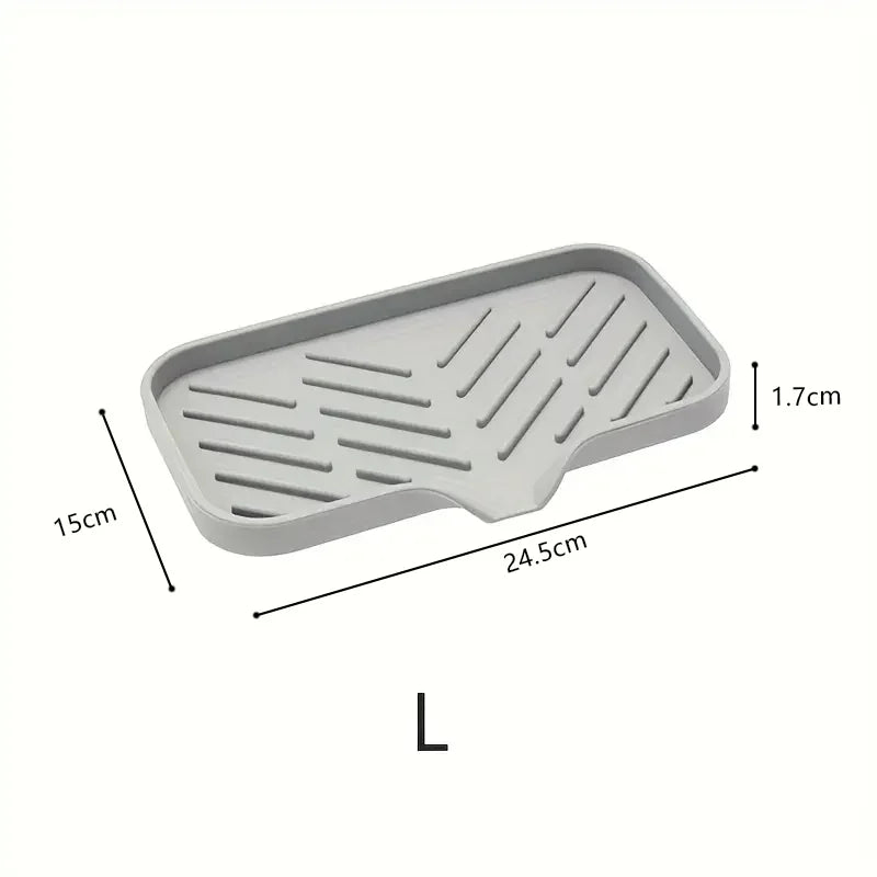 A rectangular silicone sink mat with ridges used as a kitchen organizer and drying rack.