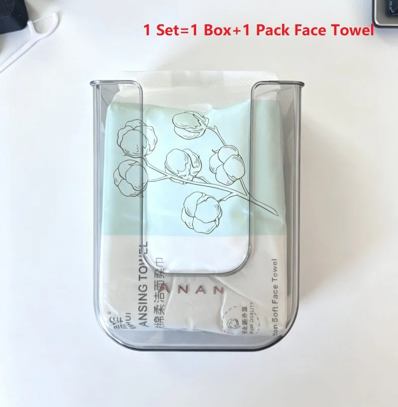 A clear plastic container holding a pack of light blue disposable cotton face towels with floral designs.