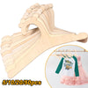 A wooden clothing hanger rack showing various sizes of hangers for kids and apparel.