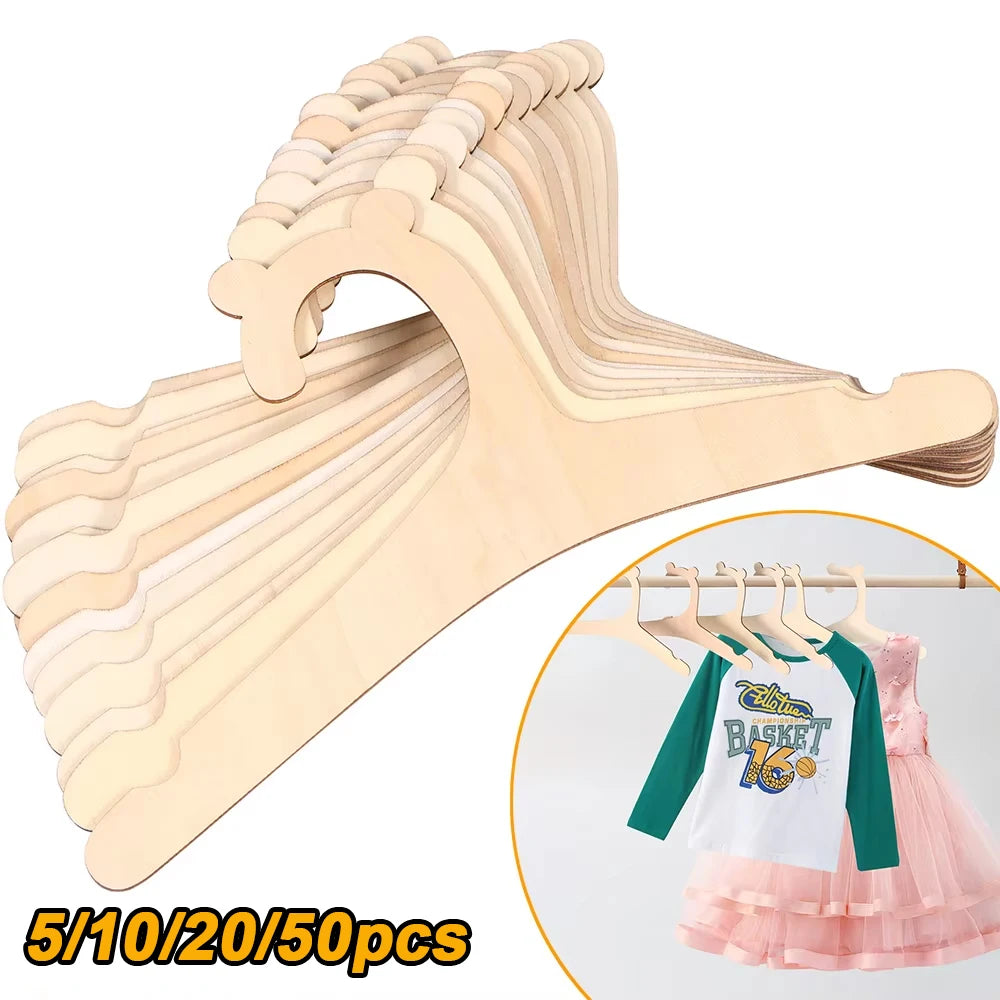 A wooden clothing hanger rack showing various sizes of hangers for kids and apparel.
