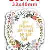 Sticker die-cut circular with floral greenery and pink accents, featuring the text 'she believed she could so she did'