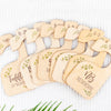 A set of wooden baby closet dividers with names and birth dates carved into the wood