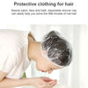 A person is using a disposable plastic shower cap to protect their hair while in a beauty salon or bath setting.