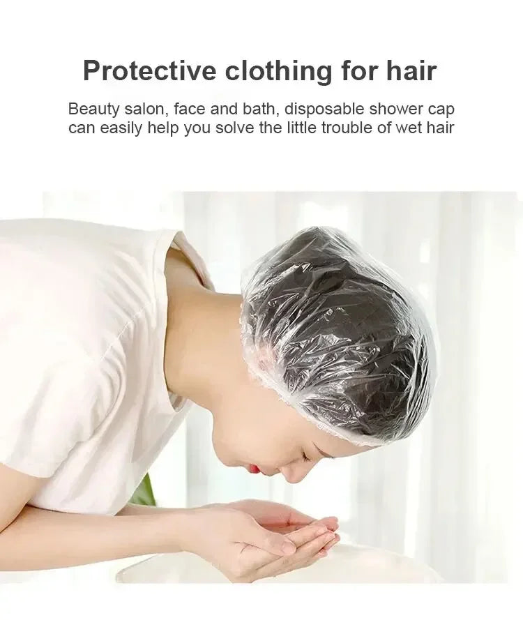A person is using a disposable plastic shower cap to protect their hair while in a beauty salon or bath setting.