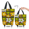 A foldable hand drawn shopping bag in brown and yellow floral patterns with black handles.