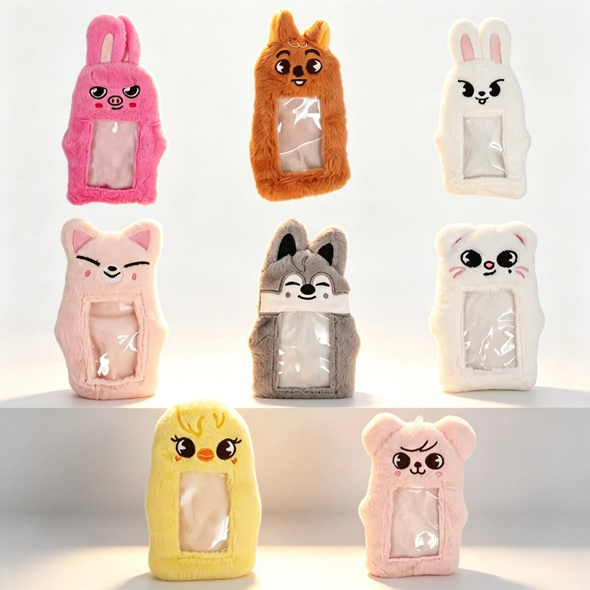 A set of plush animal-shaped storage bags in pink, orange, gray, and yellow.
