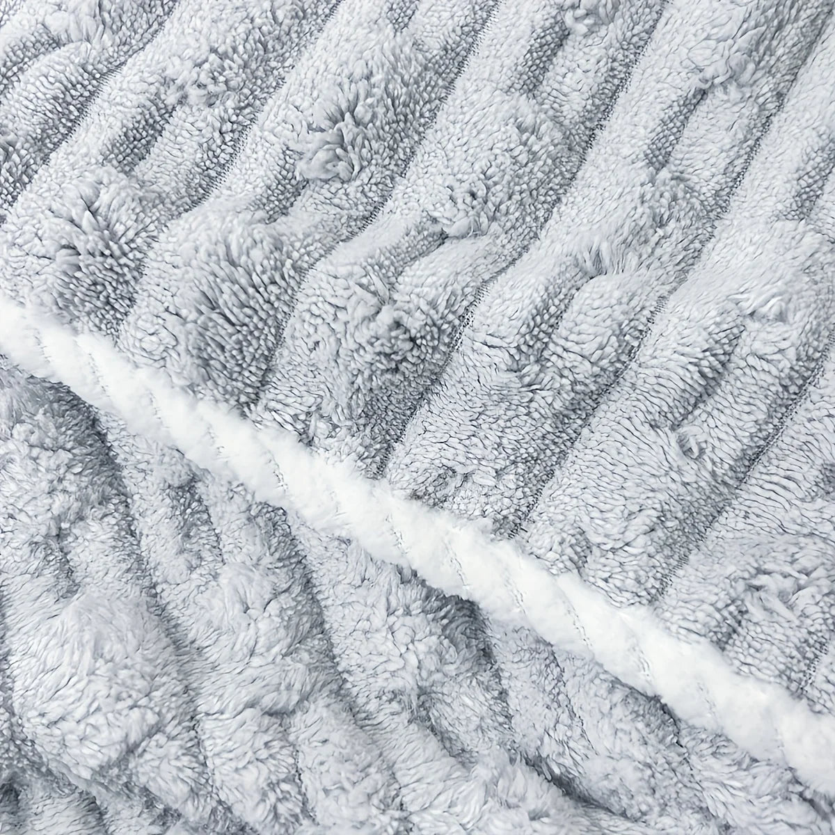 Close-up of a gray textured bath towel with diagonal stripes.