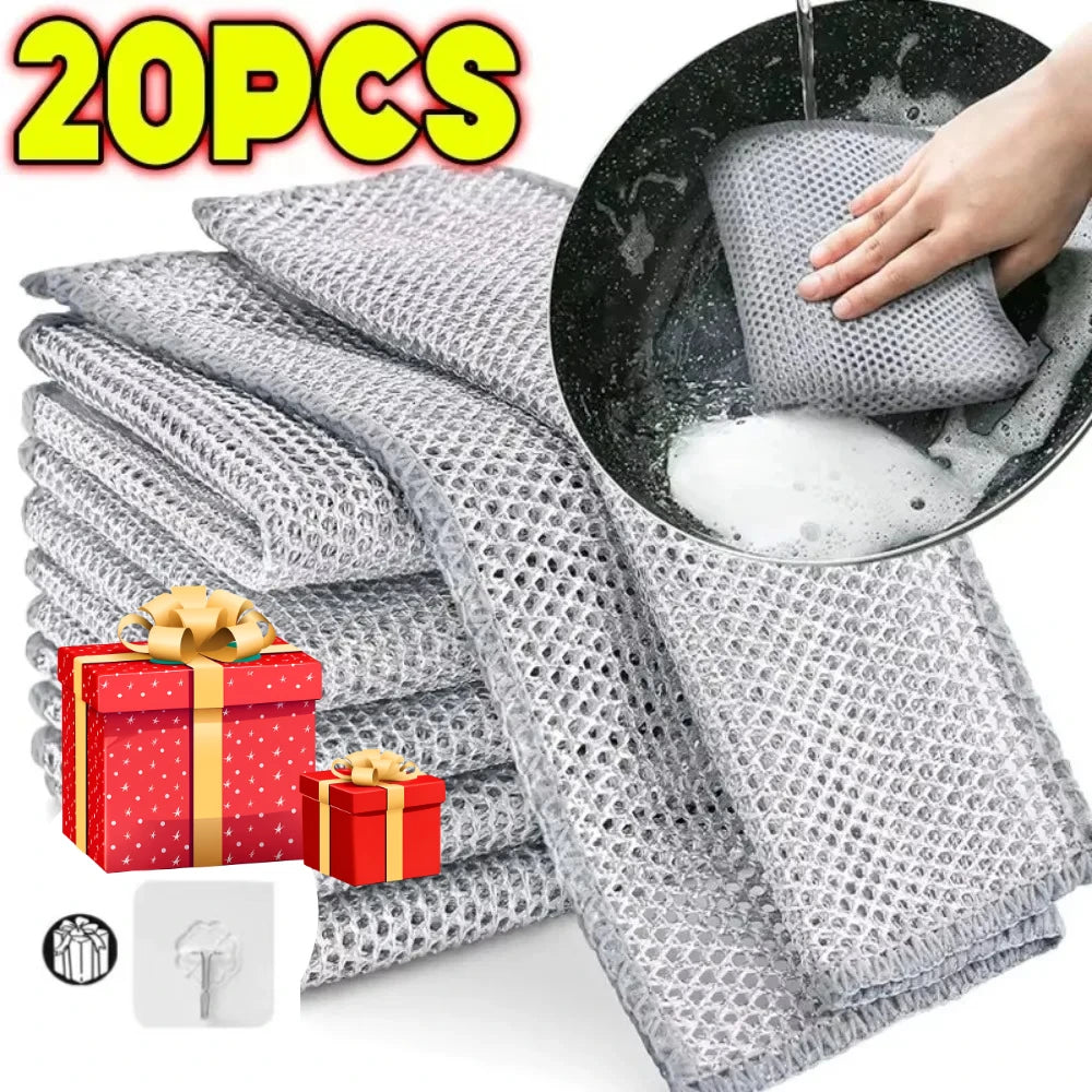 A stack of gray metal wire cleaning cloths and a hand pouring water into a circular cloth.