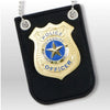 A black felt badge featuring a gold police officer seal with blue and white details and silver hanging charms.