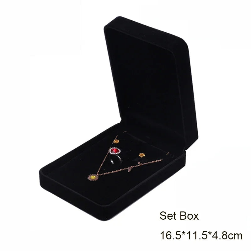 Black velvet jewelry storage box set with a lid and a tray inside
