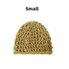 A small, hand-crocheted mesh hair net cap in a natural beige or tan color.