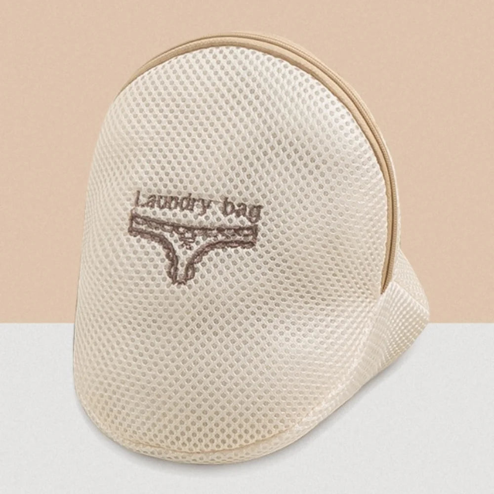A beige reusable zippered laundry bag with a mesh texture and light tan trim.