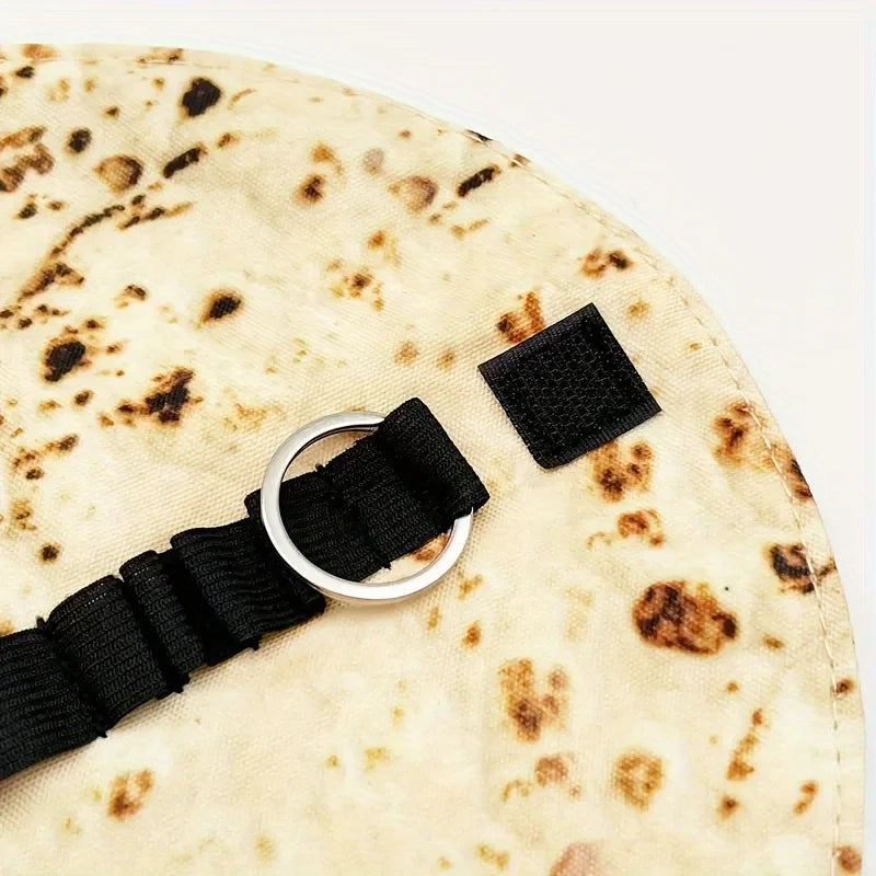A light beige canvas pencil pouch featuring a unique, mottled burrito design and black adjustable strap.