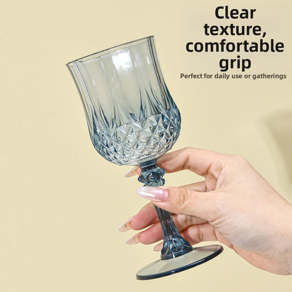 A hand holds a clear glass champagne flute with a textured grip, suitable for daily use or gatherings.