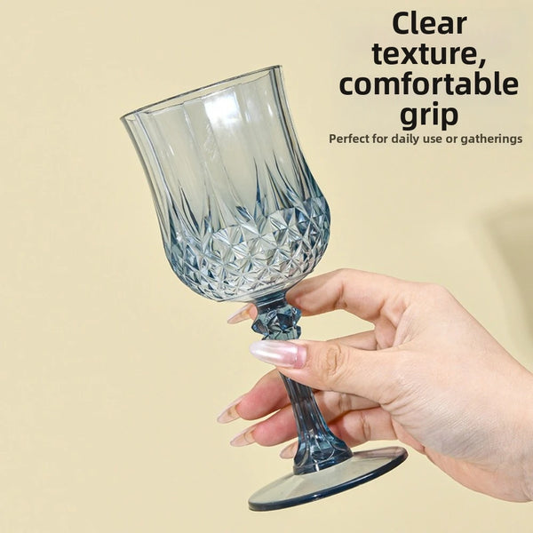 A hand holds a clear glass champagne flute with a textured grip, suitable for daily use or gatherings.