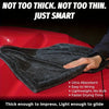 A dark gray microfiber car drying towel is shown draped over a red car hood.