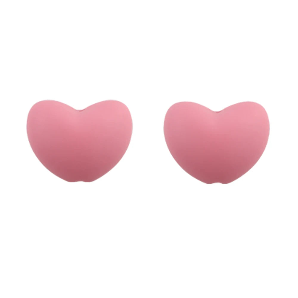 A pair of pink silicone heart charm beads for DIY jewelry.