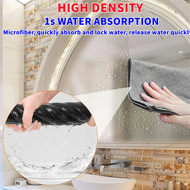 A hand is using a gray microfiber cleaning cloth to wipe a tiled surface, demonstrating water absorption.
