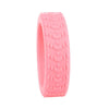 A pink silicone luggage wheel protector with a textured grip pattern.