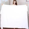 A woman holds up a large white ultra-absorbent microfiber bath towel against a light background.