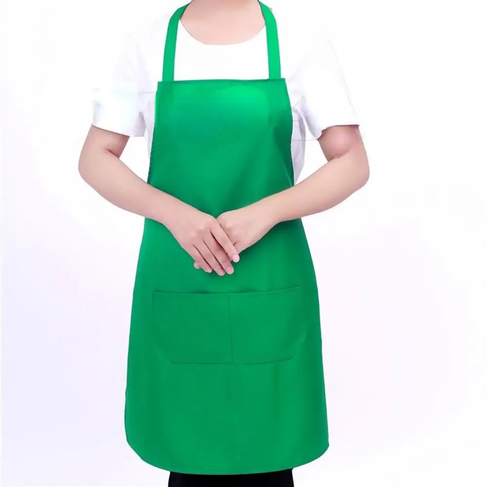 A person wearing a bright green oil-proof cooking apron over a white shirt.