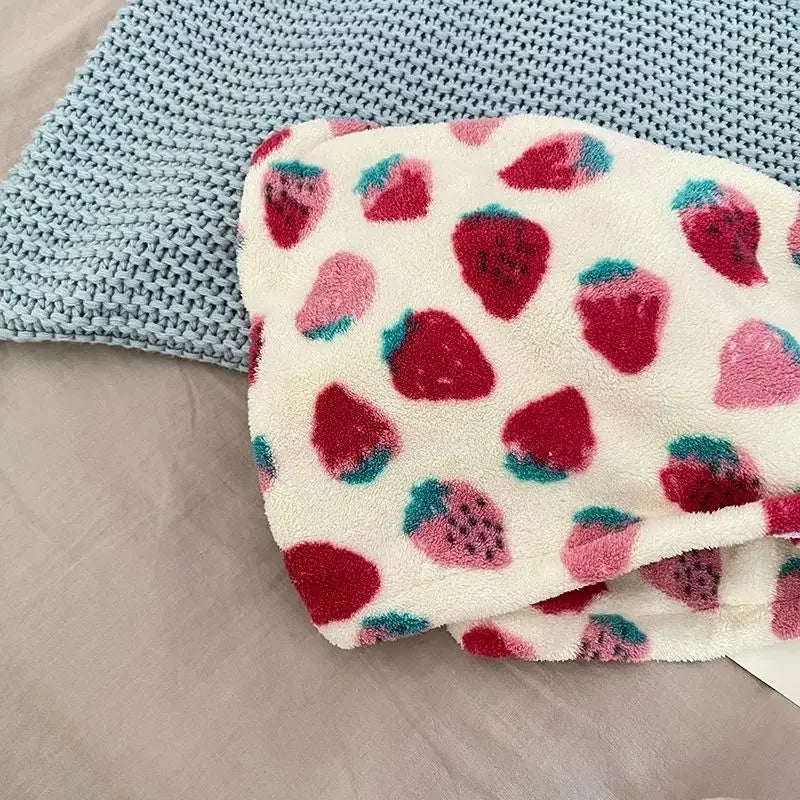 A close-up of a strawberry print quick-drying hair towel headscarf with pink and red fruit patterns.
