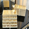 A light beige 5-tier desktop jewelry organizer rack with multiple compartments for storing rings and earrings.