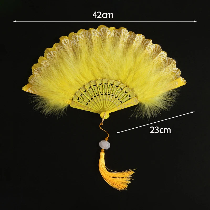 Yellow lace fabric folding hand fan with a decorative fan and tassel