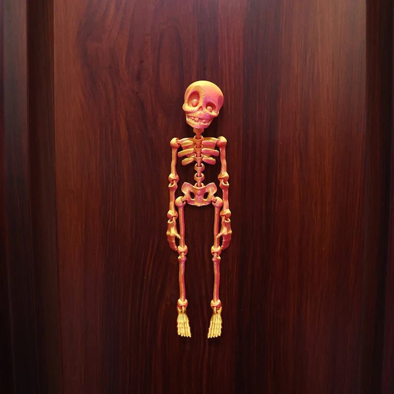 A set of luminous magnetic poseable skull fridge magnets displayed against a dark wood background.