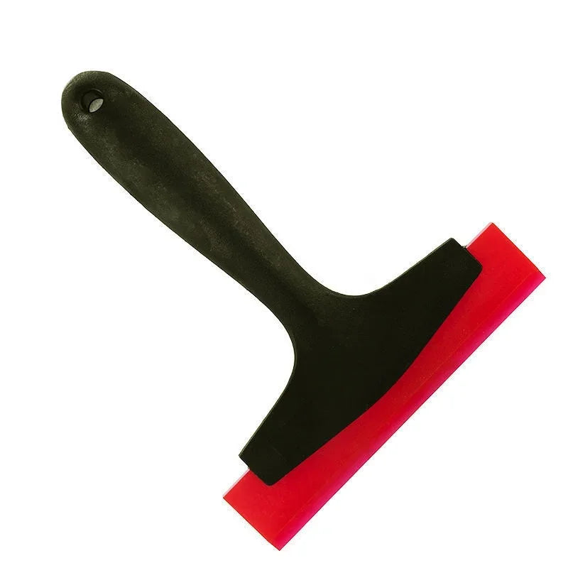 A black silicone scraper with a red edge used for grout and gap filling.