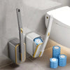 A reusable toilet cleaning brush and brush holder are shown next to a white toilet on a tiled floor.