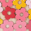 A collection of colorful wooden flower shapes used as behavior rewards.
