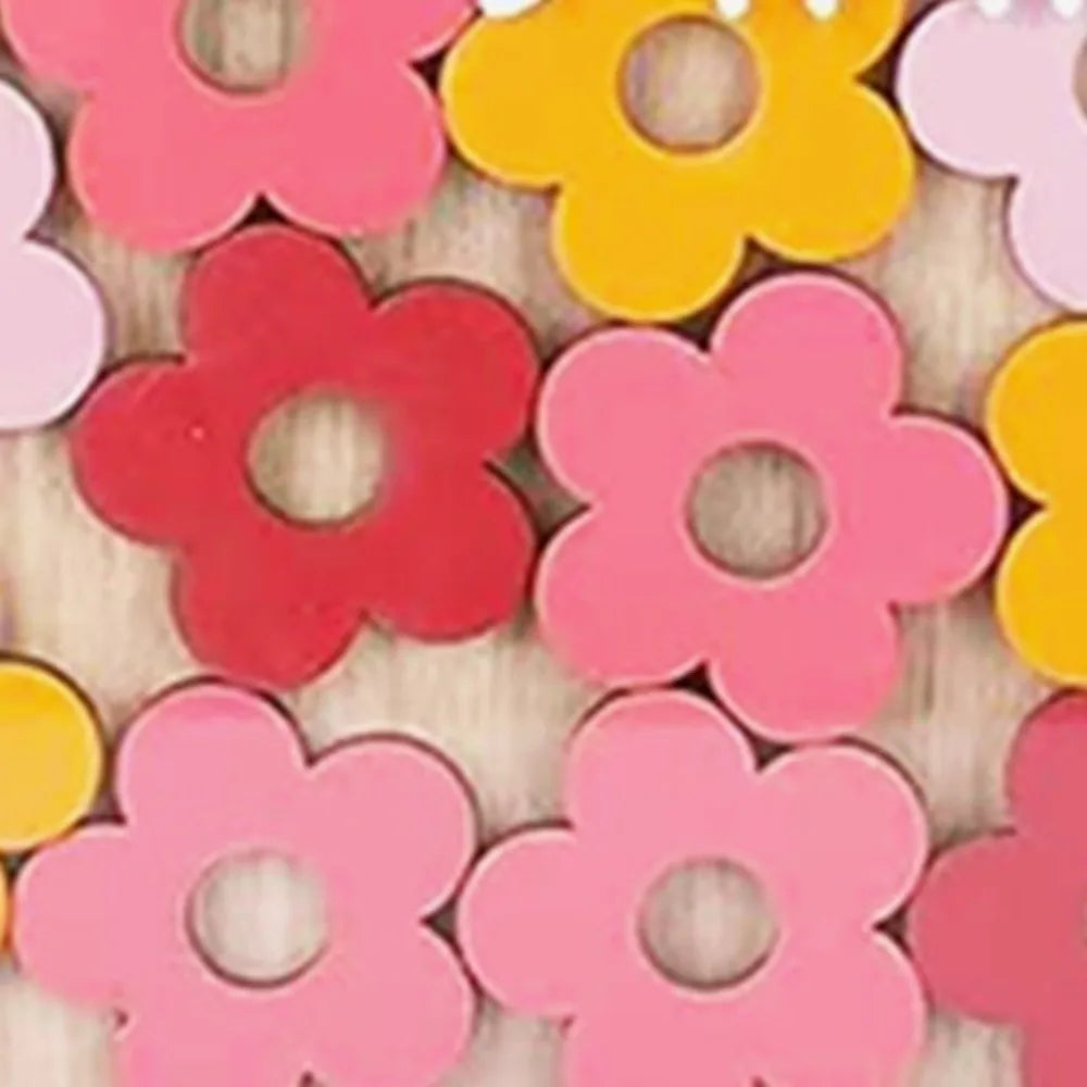 A collection of colorful wooden flower shapes used as behavior rewards.