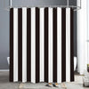 A shower curtain featuring vertical black and white stripes hanging from a metal rod.