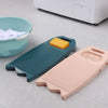 A teal plastic washing board and a pink plastic washing board are shown next to a white appliance.