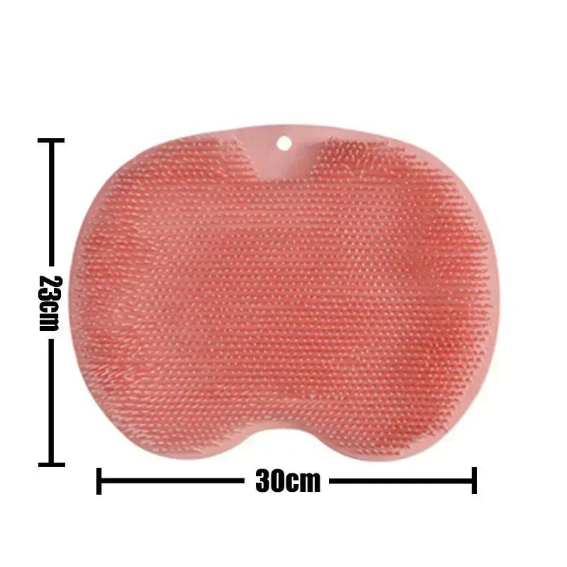 A pink reusable silicone foot scrub brush with a textured surface and a hole for drainage.
