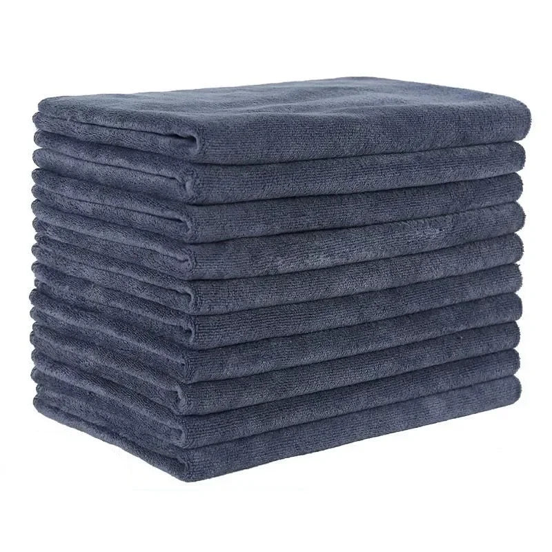 A stack of dark blue ultra-absorbent microfiber bath towels.