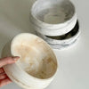 A hand holds a white silicone resin mold for baking and crafts, showing its texture and round shape.