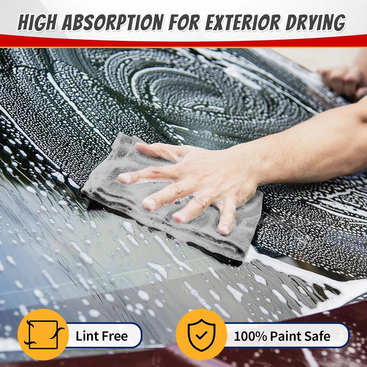 A hand wipes water spots off a car's exterior using a gray microfiber cloth for high absorption cleaning.