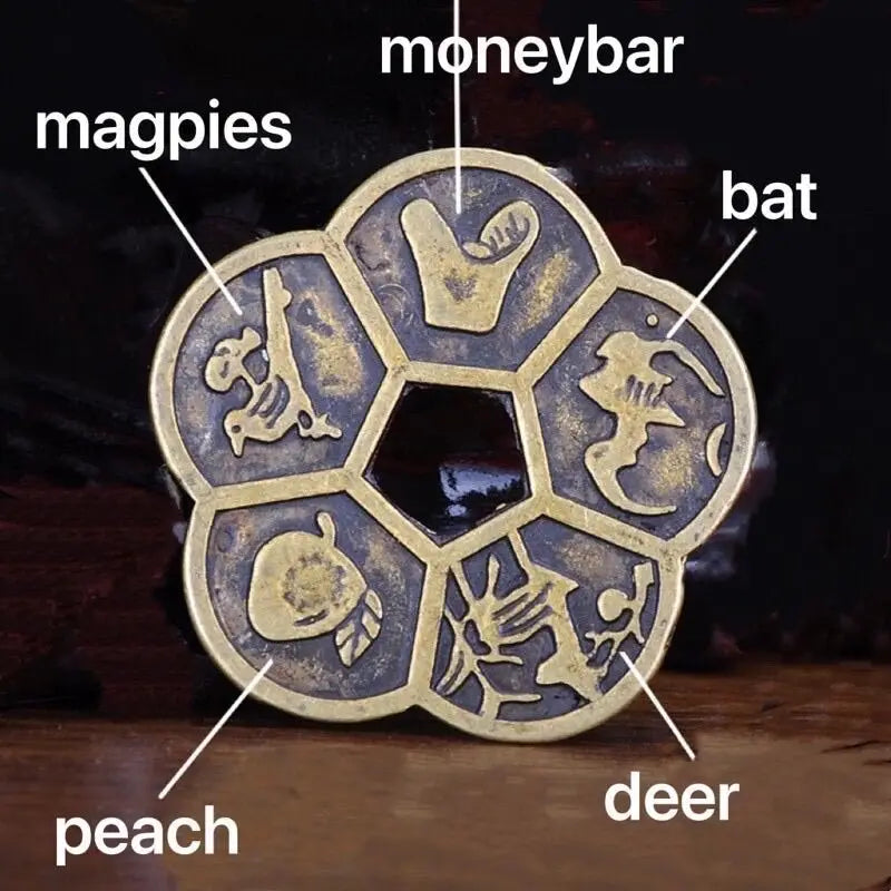 A set of traditional copper Feng Shui coins featuring animals like magpies, bat, peach, and deer.