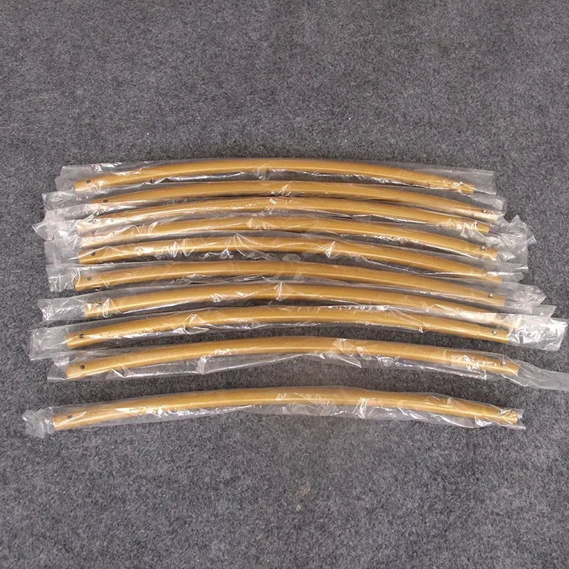 A collection of gold arch stands packaged in plastic for party decor.