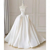 A white bridal gown displayed on an adjustable female dress form mannequin.