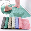 A collection of silicone bath mats in various colors and shapes, including a rectangular dolphin mat.
