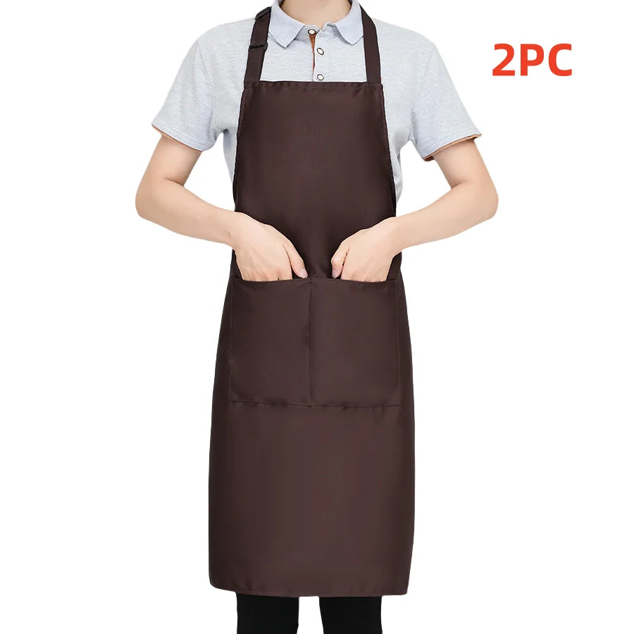 A person is wearing a dark brown chef apron over a light gray shirt, with a 2PC label visible.