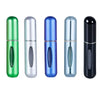 A set of five portable refillable perfume spray bottles in various colors including green, silver, blue, and black.