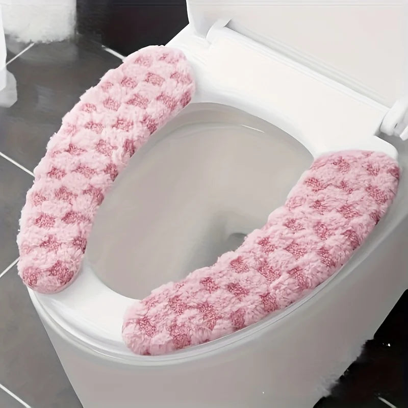 A pink, fluffy washable toilet seat cushion cover is shown inside a white toilet bowl.
