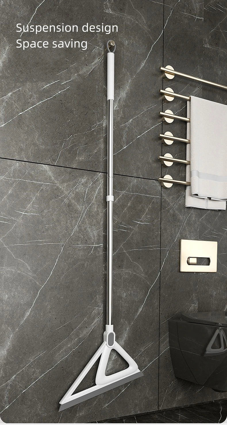 A silver silicone suspension design for a window or surface cleaner hanging on a dark marble wall.