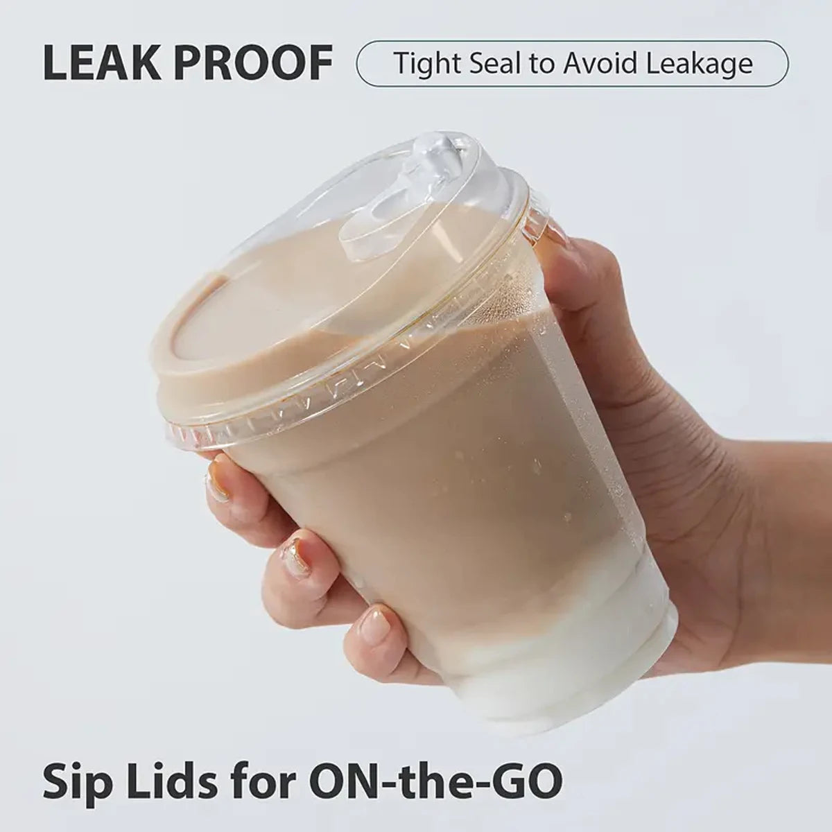 A hand holds a clear reusable disposable coffee cup with a tight seal lid, demonstrating leak proof design for on-the-go use.